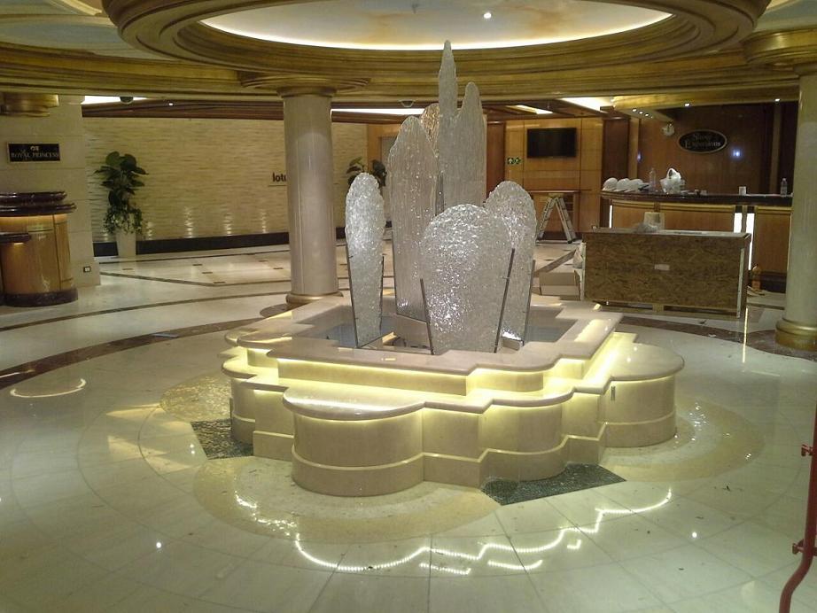 Royal Princess Piazza Fountanin. Solid curved pieces covering of crema marfil marble